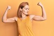 Young caucasian woman wearing casual style with sleeveless shirt showing arms muscles smiling proud. fitness concept.
