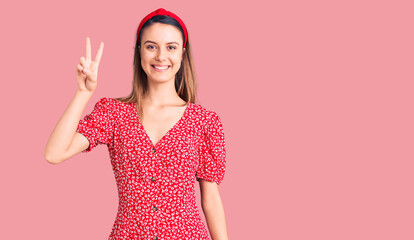 Canvas Print - Young beautiful girl wearing dress and diadem smiling looking to the camera showing fingers doing victory sign. number two.