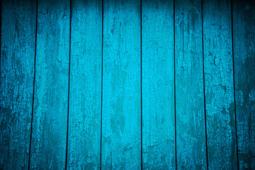 Aged blue planks with peeled paint. Blue background. Close-up. Copy space. Defocus.