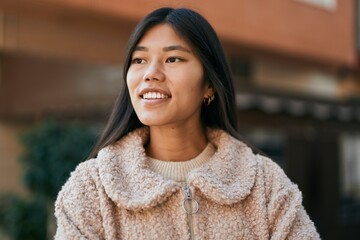 Sticker - Young asian woman smiling happy standing at the city.