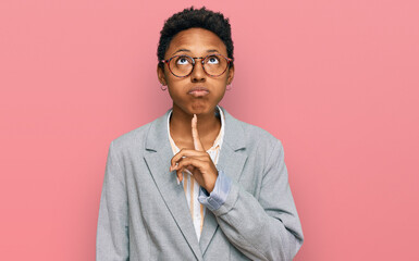 Wall Mural - Young african american woman wearing business clothes thinking concentrated about doubt with finger on chin and looking up wondering