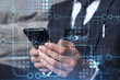 © VideoFlow - Programmer holding in the hands a smart phone and testing an innovative application to provide a completely new service. Close up shot. Hologram tech graphs. Concept of Dev team. Formal wear.