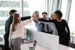 © fizkes - Excited multiethnic employees colleagues give high five celebrate shared work success or achievement. Overjoyed diverse multiracial businesspeople triumph engaged in teambuilding activity in office.