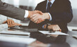© Iryna - Handshake as successful negotiation ending, close-up. Unknown business people shaking hands after contract signing in modern office