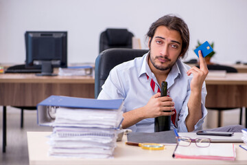 Poster - Young male employee drinking alcohol in the office