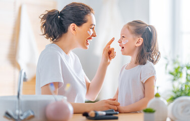 Wall Mural - mother and daughter caring for skin