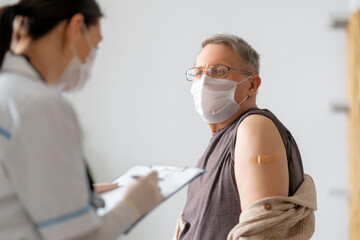 Canvas Print - Senior man after vaccination.