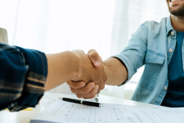Wall Mural - engineer, architect, construction worker team hands shaking after plan project contract on workplace desk in meeting room office at construction site, contractor, partnership, construction concept