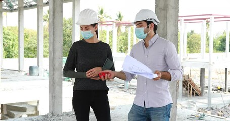 Wall Mural - Builder and engineering in protective face mask working On construction Building Site Looking At Plans