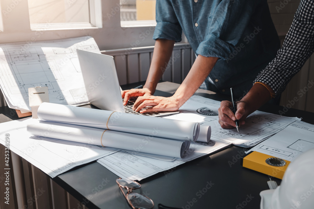 Architect man engineer construction concept using blueprints laptop at ...