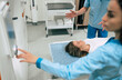 © My Ocean studio - Professional Doctor Radiologist In Medical Laboratory Controls magnetic resonance imaging or computed tomography or PET Scan with Female Patient Undergoing Procedure.