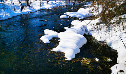 Wall Mural - Winter beautiful northern landscape river bank in the snow in a snowy forest silence.