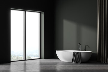 Grey and green bathroom interior with white bathtub, concrete floor and window