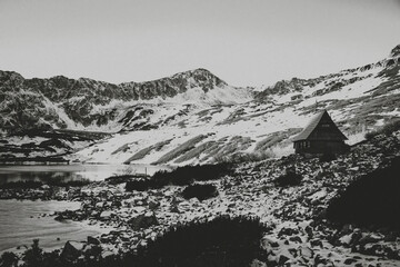 Creative grainy black and white visualisation of Tatra Mountains. Picture inspired by old postcards. Selective focus on the rocks, blurred background.