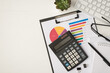 © ActionGP - Top view photo of business workplace with keyboard glasses binders pen notebook plant and calculator on pie chart diagram on isolated white background with copyspace