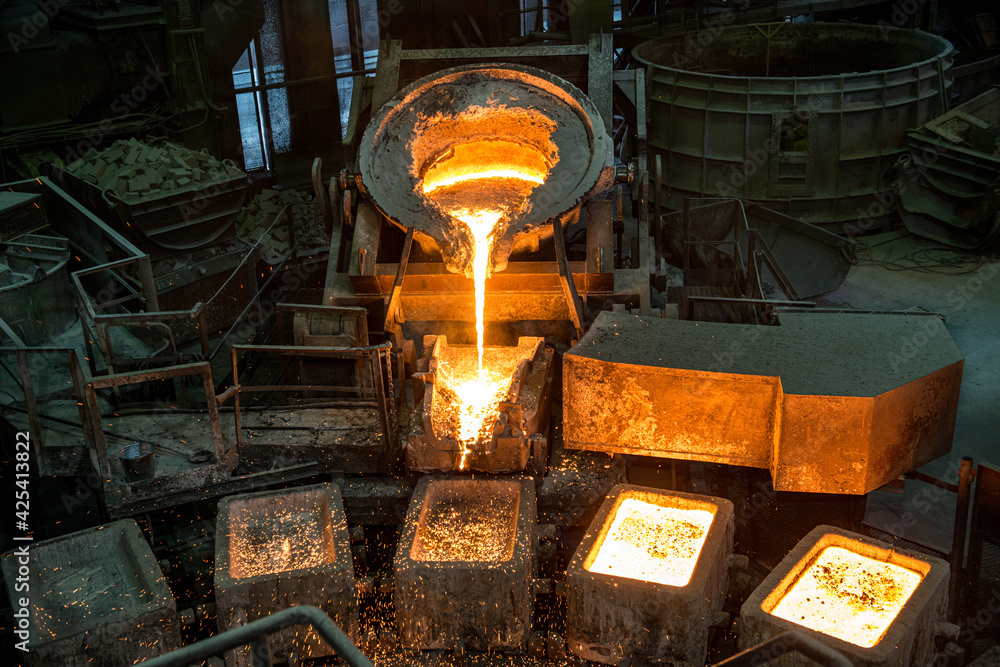 Tank pours liquid metal in the molds by carousel machine Stock Photo ...