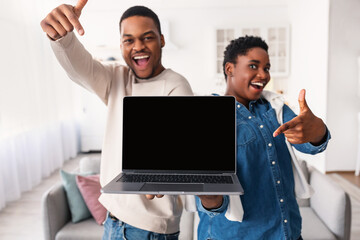 Black couple showing blank empty laptop screen for mock up