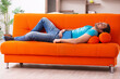 © Elnur - Young male student sitting on the orange sofa