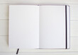 White empty sketchbook pages on white wood