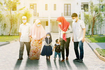 Wall Mural - Muslim family in face mask walks together on road