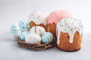 Easter russian cake and colorful eggs, flower on blue background