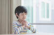 © lalalululala - Cute Asian child boy praying with eyes closed in the morning