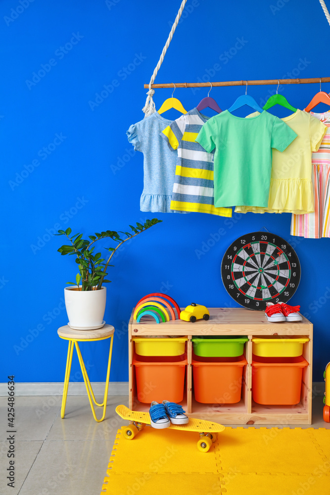 Rack with clothes in interior of children's room