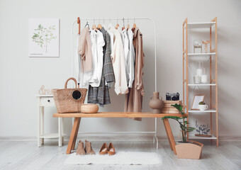 Sticker - Rack with clothes in interior of modern room