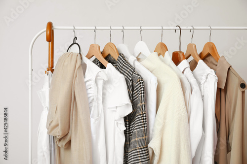 Obraz Dibond Rack with modern clothes in room