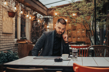 businessman using smartphone in a cafe