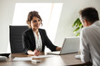 © bnenin - Portrait of a smiling businesswoman talking to a client.