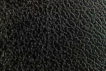 Macro photography of a black leather texture. A close-up image that shows the details and patterns of the material