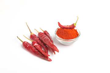 Dried red chilli and powder in glass bowl on white background.