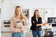 © contrastwerkstatt - Two happy successful businesswomen posing in the office