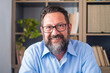 © Daniel - Portrait of one young and happy cheerful man smiling looking at the camera having fun. Headshot of male person working at home in the office..