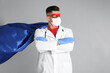 © New Africa - Doctor wearing face mask and cape on grey background. Super hero power for medicine