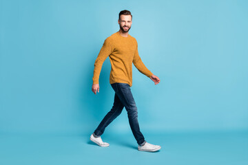 Wall Mural - Full length body size view of attractive cheerful glad guy wearing casual walking isolated over bright blue color background