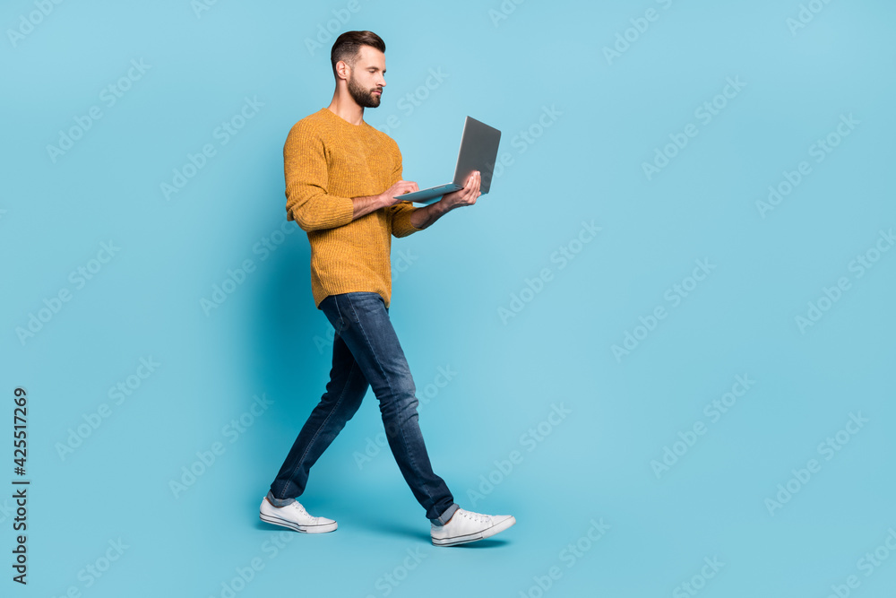 Full length body size view of attractive skilled focused guy employee going using laptop isolated over bright blue color background - obrazy, fototapety, plakaty 