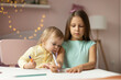 © Evgenia Tiplyashina - two children draws at the table in the room,