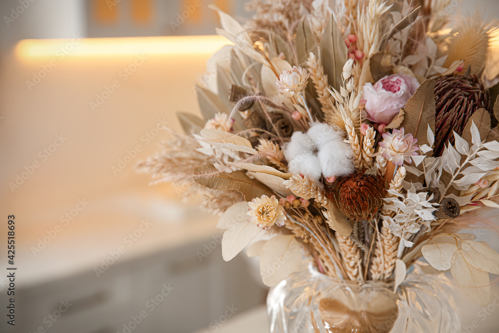 Bouquet of dry flowers and leaves in kitchen. Space for text - obrazy, fototapety, plakaty 