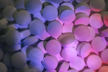 Fototapete - Pills or drugs in a package under neon light. Beautiful background pattern for design.
