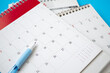 © Kwangmoozaa - calendar page with pen close up on blue background business planning appointment meeting concept