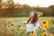 © Kristina89 - Young Asian woman with curly hair in a field of sunflowers at sunset. Portrait of a young beautiful asian woman in the sun.