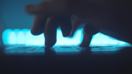 Woman writes message using laptop keyboard. Typing text in document on computer. Journalist write article. Working on laptop at night. Digital technologies. Gadget. Blue light. 4K macro footage