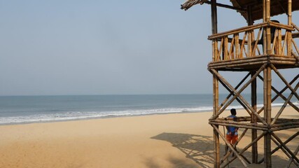 Wall Mural - Full view of seashore, Man standing at the shore of sea