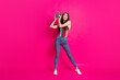 © deagreez - Full size photo of optimistic nice brunette lady hold disco ball wear top jeans sneakers isolated on vivid pink color background