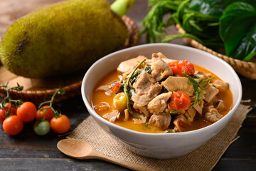 Canvas Print - Northern Thai food (Kang Kanoon), Spicy young jackfruit soup with pork in a bowl on wooden table