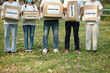 © DragonImages - Cropped image of volunteers with donation boxes full of clothes and groceries standing park