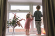 © Myroslava - Happy children standing on the windowsill, looking through the window. Little girl and boy.