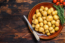 Raw Baby Mini Potatoes. Dark Wooden Background. Top View. Copy Space